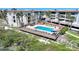 A beautiful aerial shot of the community pool deck with lounge chairs and a tiki hut at 1501 Beach Rd # 303, Englewood, FL 34223