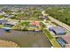 Aerial view of waterfront property featuring a private pool, dock, and expansive canal access in a desirable neighborhood at 15020 Acorn Cir, Port Charlotte, FL 33981