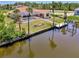Waterfront property with a pool, private dock, lush landscaping, and easy access to the waterway, perfect for boaters at 15020 Acorn Cir, Port Charlotte, FL 33981