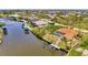 Aerial shot of waterfront home with private pool and dock, offering stunning canal views and easy water access at 15020 Acorn Cir, Port Charlotte, FL 33981