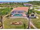 Aerial view of private pool, lush backyard, and waterway access, perfect outdoor oasis for enjoying the water at 15020 Acorn Cir, Port Charlotte, FL 33981