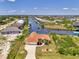 Waterfront home features tile roof, mature landscaping, boat dock and stunning views of the canal at 15020 Acorn Cir, Port Charlotte, FL 33981