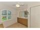Bright bathroom featuring a double vanity, shuttered windows, and tile floors at 15020 Acorn Cir, Port Charlotte, FL 33981