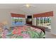 Bedroom featuring a double bed and a view of the pool deck and canal at 15020 Acorn Cir, Port Charlotte, FL 33981