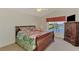 Bedroom featuring a double bed and a nice view; includes a large wood dresser at 15020 Acorn Cir, Port Charlotte, FL 33981
