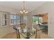 Elegant dining area with glass table offers views of the pool and lanai at 15020 Acorn Cir, Port Charlotte, FL 33981