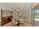 Formal dining room with glass table next to sliding door to pool area at 15020 Acorn Cir, Port Charlotte, FL 33981