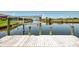 Private dock with boat lift showcasing direct water access and serene canal views, great for boating and fishing at 15020 Acorn Cir, Port Charlotte, FL 33981