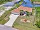 Single-Gathering home with large driveway, landscaping, and two-car garage in a waterfront community at 15020 Acorn Cir, Port Charlotte, FL 33981