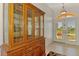 View of foyer featuring arched doorway, tile floor, and glass cabinet for displaying decor at 15020 Acorn Cir, Port Charlotte, FL 33981