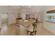Bright open-concept kitchen with eat-in bar, and comfortable dining table at 15020 Acorn Cir, Port Charlotte, FL 33981