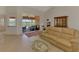 Inviting living room featuring a comfortable sofa and seamless access to the outdoor patio at 15020 Acorn Cir, Port Charlotte, FL 33981