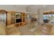 Open concept living room featuring tile floors, tall ceilings, and a beautiful view of the outdoors at 15020 Acorn Cir, Port Charlotte, FL 33981