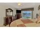 This waterfront main bedroom features a large window and dresser at 15020 Acorn Cir, Port Charlotte, FL 33981