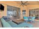 Relaxing screened-in lanai with stylish furniture, ceiling fan, and easy access to indoor living spaces at 15020 Acorn Cir, Port Charlotte, FL 33981