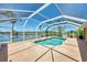 Sparkling pool enclosed in a screened lanai, offering privacy and a relaxing outdoor space at 15020 Acorn Cir, Port Charlotte, FL 33981