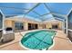 Beautiful pool surrounded by a screened lanai, providing a private and enjoyable outdoor experience at 15020 Acorn Cir, Port Charlotte, FL 33981
