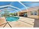 Inviting pool area with a screened enclosure, perfect for outdoor entertaining and relaxation at 15020 Acorn Cir, Port Charlotte, FL 33981