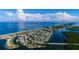 Scenic aerial view of a coastal community with a beachfront, a waterway, and boats docked nearby at 1551 Beach Rd # 212, Englewood, FL 34223