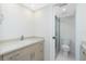 A well-lit bathroom featuring a granite vanity and glass-enclosed shower at 1551 Beach Rd # 212, Englewood, FL 34223