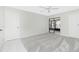 A modern bedroom with carpet, a ceiling fan, and sliding glass doors to a balcony at 1551 Beach Rd # 212, Englewood, FL 34223