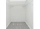 A well-lit, empty walk-in closet with wire shelving and neutral carpet at 1551 Beach Rd # 212, Englewood, FL 34223