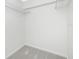 An empty walk-in closet with wire shelving and neutral carpet at 1551 Beach Rd # 212, Englewood, FL 34223