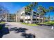 Exterior building view showcasing manicured landscaping, parking, and multiple floors at 1551 Beach Rd # 212, Englewood, FL 34223