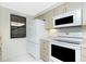 Kitchen with updated appliances, neutral cabinets, and window for natural light offering a modern feel at 1551 Beach Rd # 212, Englewood, FL 34223