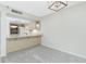 Inviting kitchen featuring a breakfast bar, light wood cabinetry and stainless steel appliances at 1551 Beach Rd # 212, Englewood, FL 34223