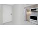 Entryway to kitchen with white tile floors, stainless steel appliances, and neutral-toned cabinets at 1551 Beach Rd # 212, Englewood, FL 34223