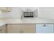 Open kitchen design showcasing light countertops, a sink, and white appliances flowing into the bright living space at 1551 Beach Rd # 212, Englewood, FL 34223