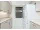 Bright kitchen featuring white appliances, neutral-tone cabinets, ample counter space, and a window at 1551 Beach Rd # 212, Englewood, FL 34223