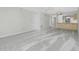 Open-concept living area flows into kitchen with a ceiling fan and neutral paint at 1551 Beach Rd # 212, Englewood, FL 34223