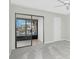 Spacious living room with sliding glass doors and a ceiling fan at 1551 Beach Rd # 212, Englewood, FL 34223