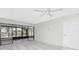 Large living room boasts sliding glass doors, a ceiling fan and neutral color palette at 1551 Beach Rd # 212, Englewood, FL 34223