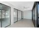 Bright living room boasts tile flooring and sliding glass doors with beautiful tropical views at 1551 Beach Rd # 212, Englewood, FL 34223