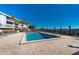 Bright outdoor pool with waterfront views surrounded by lounge chairs at this condo community at 1551 Beach Rd # 212, Englewood, FL 34223