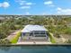 An aerial view showcasing the pool and waterfront backyard of this beautiful home at 15850 Viscount Cir, Port Charlotte, FL 33981