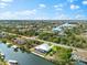 Wonderful aerial view of canal-side homes, complete with boatlifts and docks, set against a backdrop of lush vegetation at 15850 Viscount Cir, Port Charlotte, FL 33981