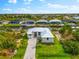 Beautiful waterfront home with a paved driveway and lush landscaping at 15850 Viscount Cir, Port Charlotte, FL 33981