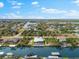 An aerial view showcasing the home's ideal location on a scenic canal, surrounded by lush landscape at 15850 Viscount Cir, Port Charlotte, FL 33981
