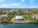 Aerial shot of a home with a backyard pool, landscaping, and access to a scenic canal at 15850 Viscount Cir, Port Charlotte, FL 33981