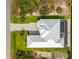 Top down aerial view of the luxurious home showing the landscaped yard, the home's roofline, and the backyard pool and lanai at 15850 Viscount Cir, Port Charlotte, FL 33981