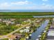 Lovely neighborhood view from above of residences located on canals with boat docks, water views, and landscaping at 15850 Viscount Cir, Port Charlotte, FL 33981