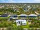 Wonderful aerial view of the waterfront home with a paved driveway and lush landscaping at 15850 Viscount Cir, Port Charlotte, FL 33981