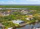 Gorgeous aerial of homes on canals featuring boatlifts plus views of the surrounding waterway and landscaping at 15850 Viscount Cir, Port Charlotte, FL 33981