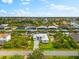 Stunning aerial view of a waterfront home with lush landscaping and canal access at 15850 Viscount Cir, Port Charlotte, FL 33981