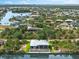 Overhead shot of waterfront home with screen enclosed lanai and pool overlooking the waterway in a beautiful tropical setting at 15850 Viscount Cir, Port Charlotte, FL 33981