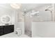 Modern bathroom with dual shower heads, chandelier, marble floors, and granite countertop vanity at 15850 Viscount Cir, Port Charlotte, FL 33981